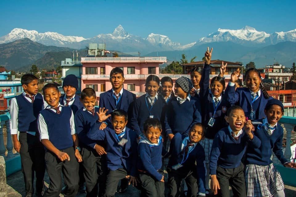 Onni children with the Himalayan mountains in the background